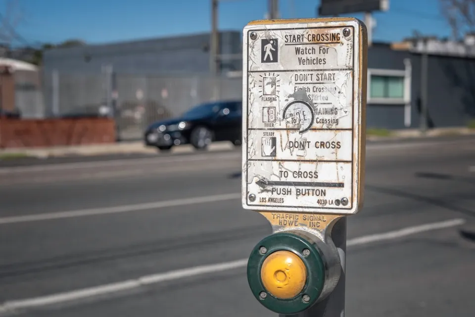 Close-up of pedestrian crossing button at a crosswalk in Los Angeles